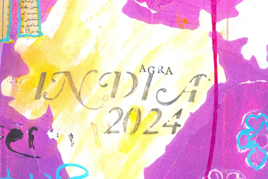 Carnet ouvert avec aquarelles colorées près d’une fenêtre méditerranéenne