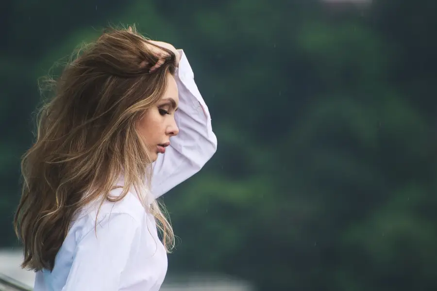 Femme séchant délicatement ses cheveux avec une brosse ronde